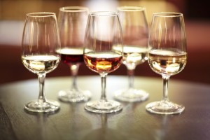 Shot of five glasses of different wines on a table
